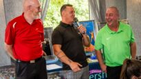 Three men laughing and joking inside the event