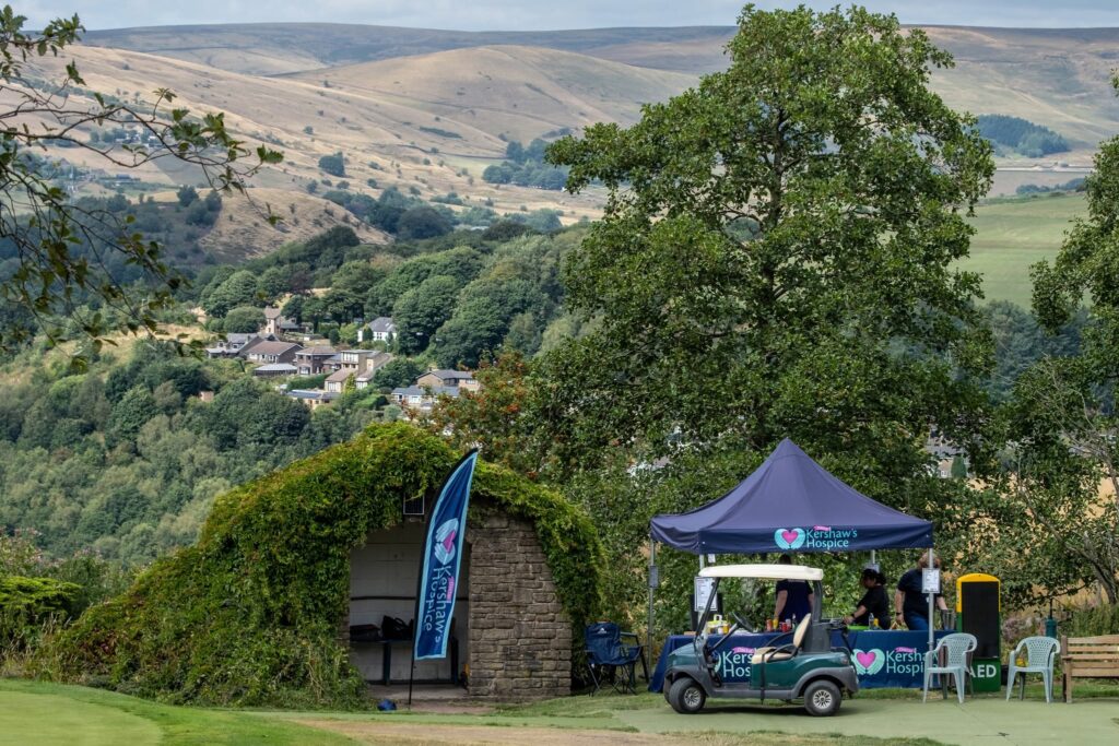 A Dr Kershaw's Hospice tent in front of a huge expanse of countryside and trees