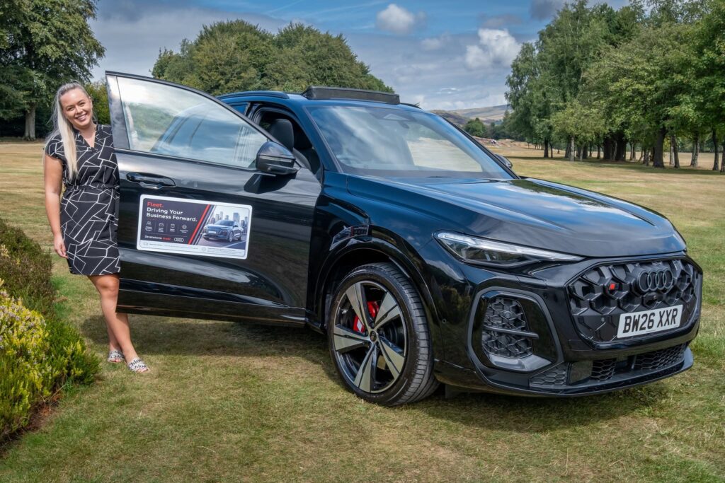 A woman with a black car on the golf course