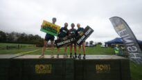 A group of four people standing on top of Born Survivor blocks holding signs saying 'Major Trauma', 'Smashed It' and 'Dream Team'