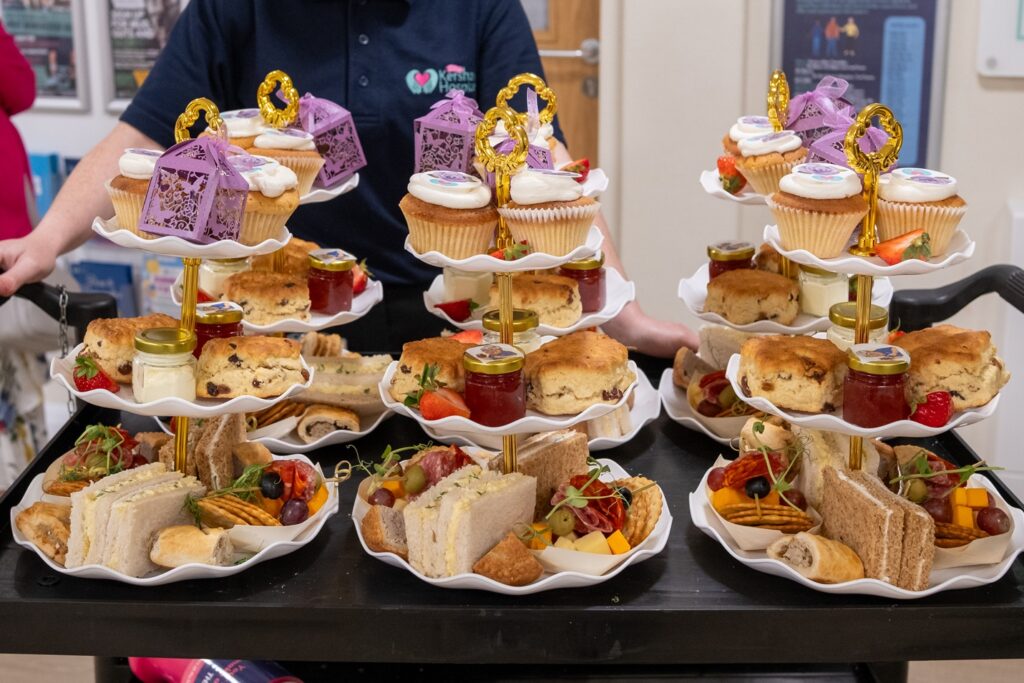 A table of afternoon tea, including cakes and sandwiches