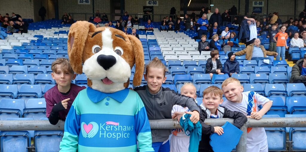Hartley in the stands with children at Oldham Athletic Football Club