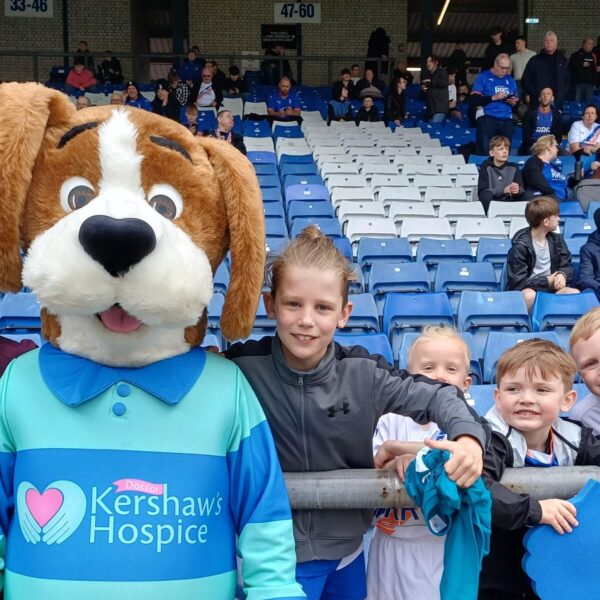 Hartley in the stands with children at Oldham Athletic Football Club