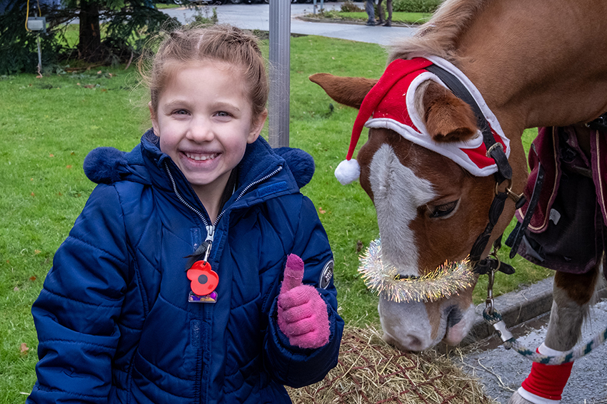 A child with Santa's pony