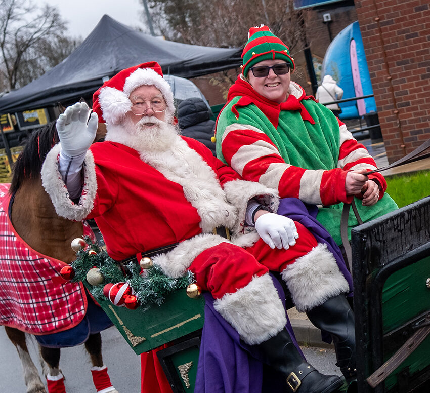 Santa and his elf arriving at the fayre