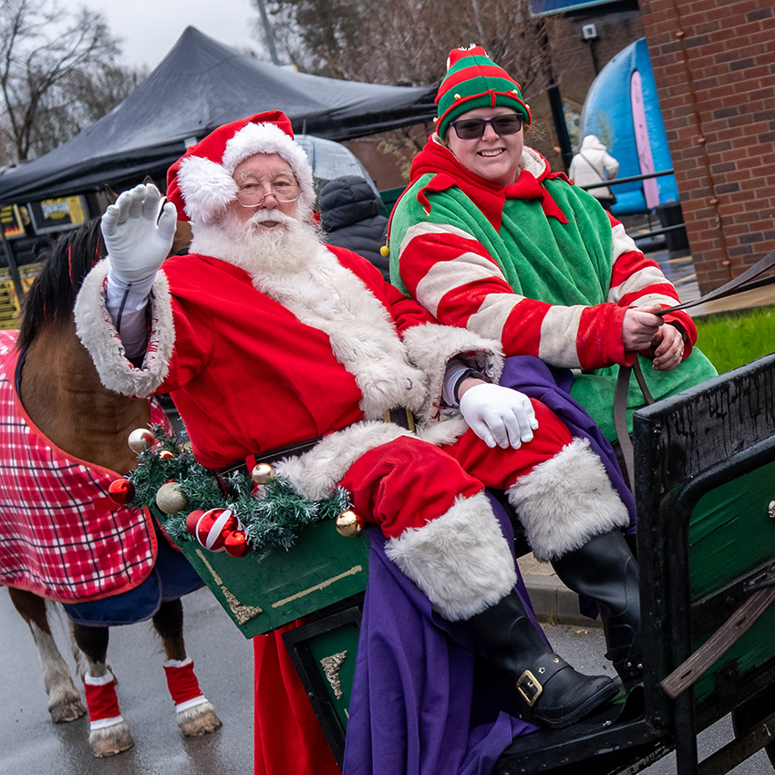Santa and his elf arriving at the fayre