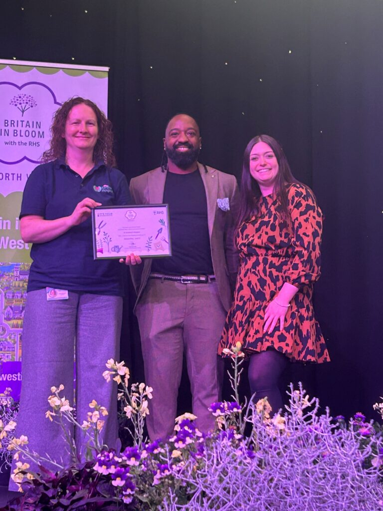 Hospice team with award winning gardener collecting their award