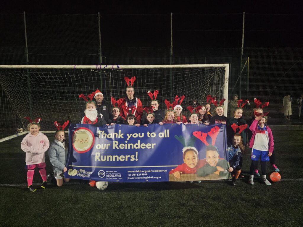 Children in reindeer antlers in front of a goalpost