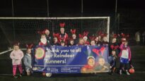 Children in reindeer antlers in front of a goalpost