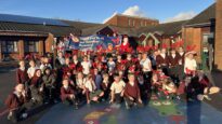 Crowd of children in antlers in a school playground