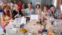 Women sat around a beautifully decorated table