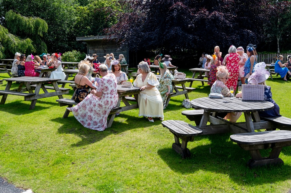 Women sat on benches outside